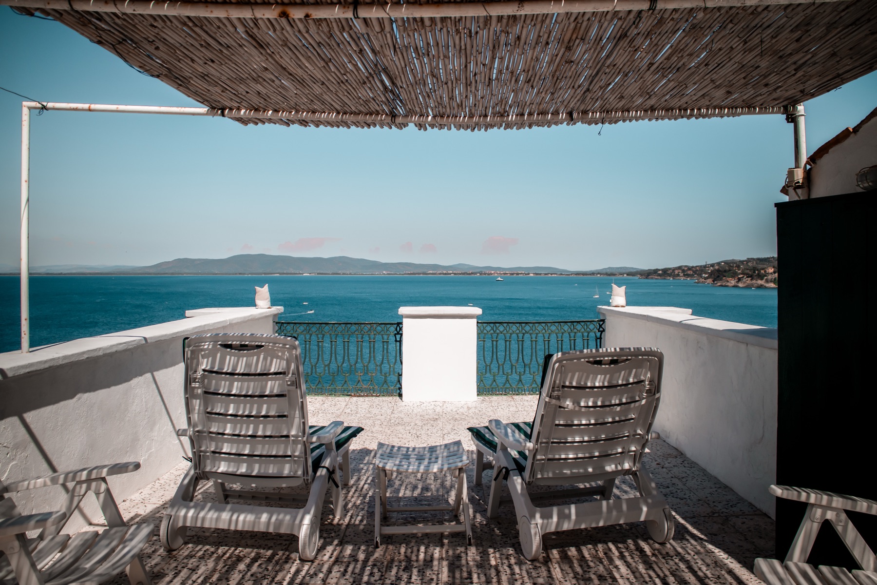 The roof terrace, with sun loungers facing the bay