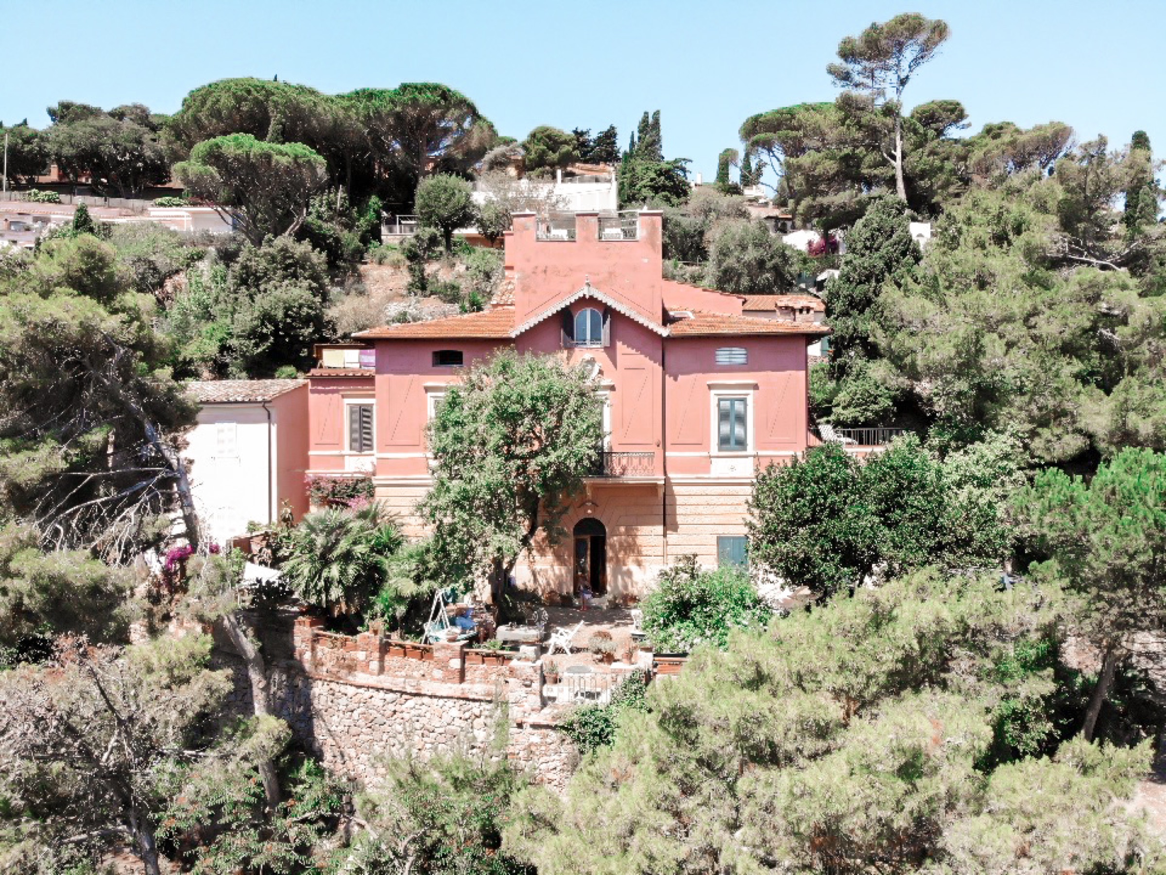 Villa Baschieri, seen from above, on a wooded hillside