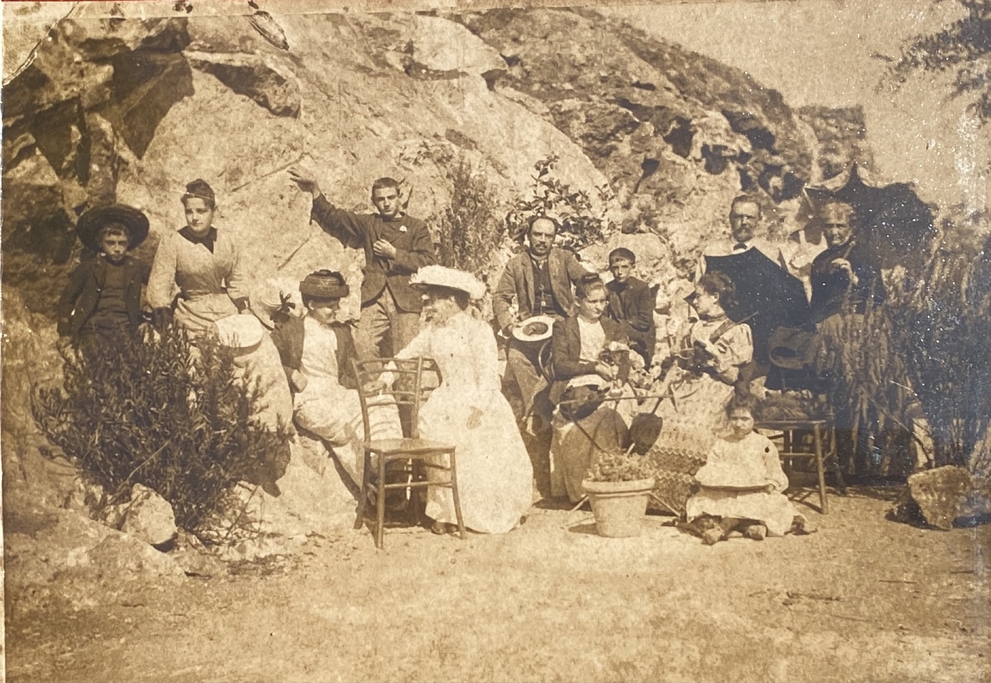 A sepia photograph of the Baschieri family on the rocks below Villa Baschieri, late 1800s